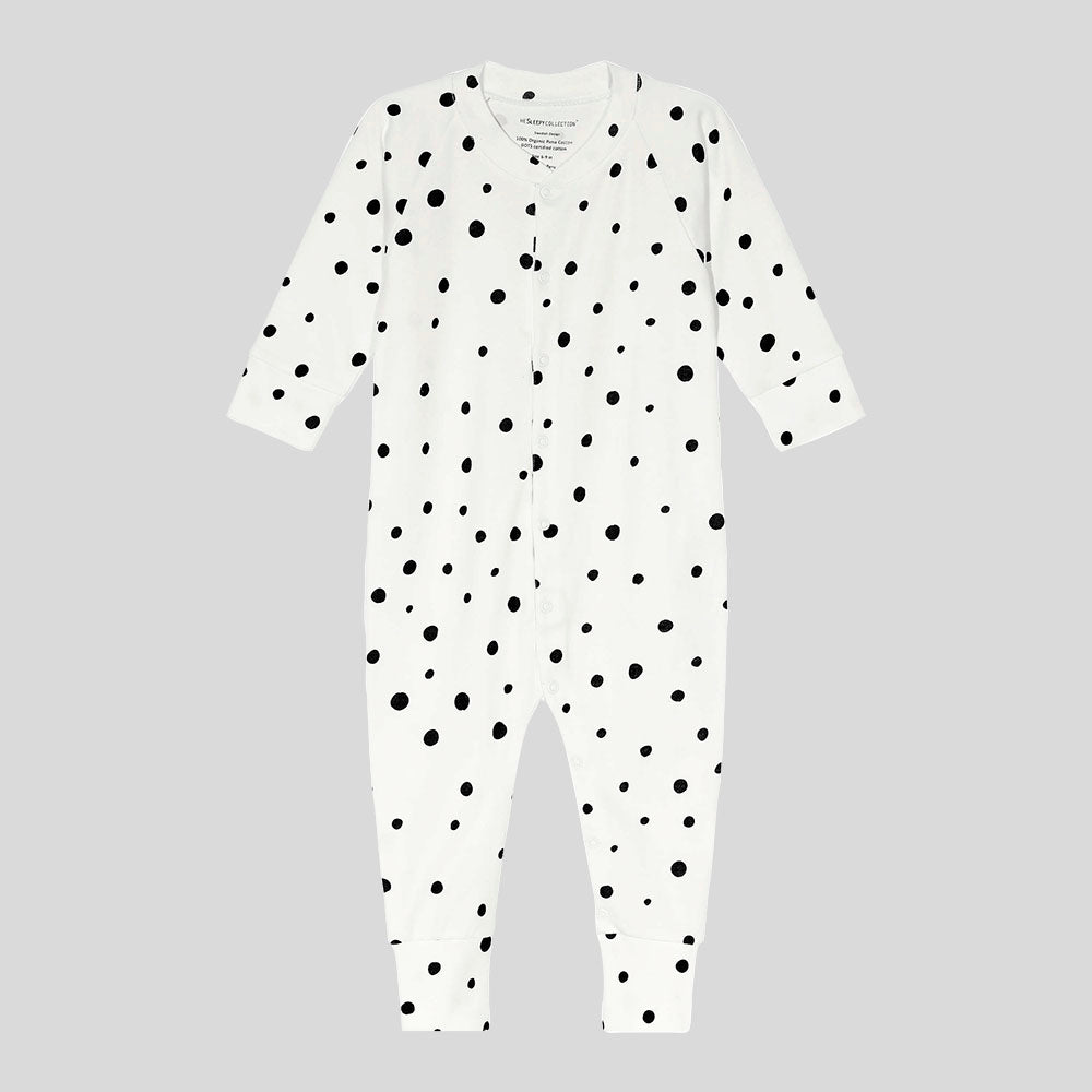 Baby sleepsuit in white, with black polka dots