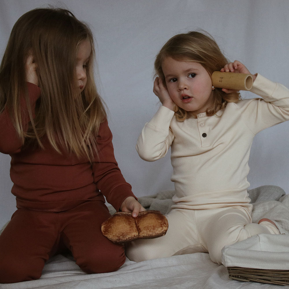Kids wearing SS20 sleepwear in color sand and rust, from The Sleepy Collection